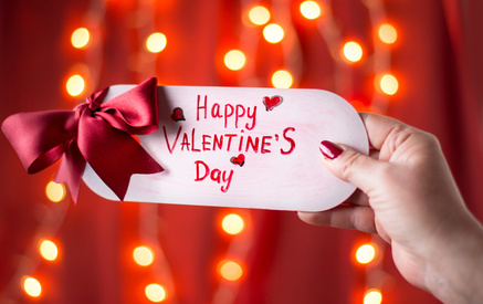 Female hand holding Happy Valentines day card